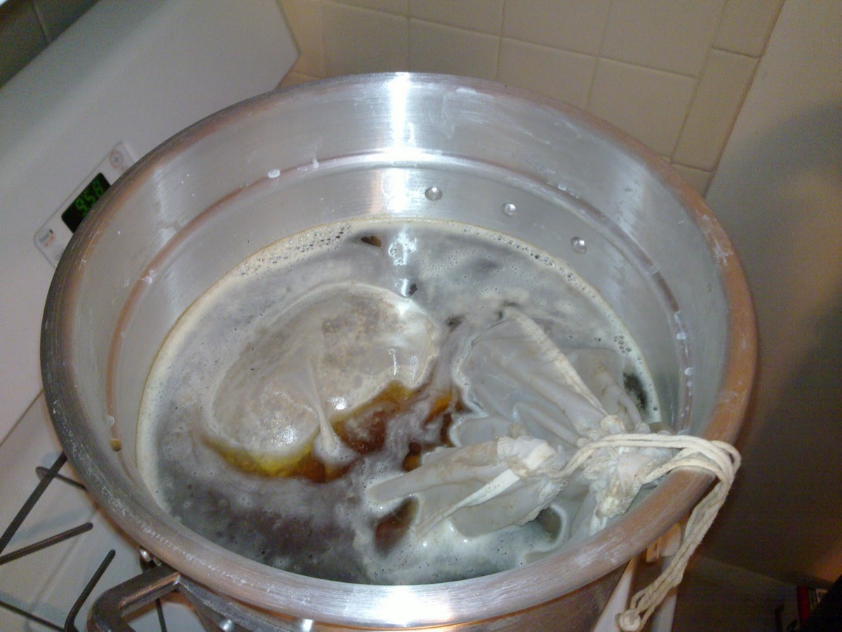 Grain in cheesecloth mashing on the apartment stove